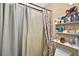 Bathroom featuring a toilet, shower with curtain, and a storage shelf at 1573 Avleigh Cir, Orlando, FL 32824