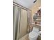 Bathroom featuring a toilet, shower with curtain, and a storage shelf at 1573 Avleigh Cir, Orlando, FL 32824