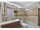 Bathroom featuring a sink, toilet, and tiled shower with glass doors at 1573 Avleigh Cir, Orlando, FL 32824