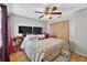 Comfortable bedroom features hardwood floors, a ceiling fan, and natural light from the window at 1573 Avleigh Cir, Orlando, FL 32824