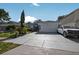 Charming home featuring an attached garage and long driveway at 1573 Avleigh Cir, Orlando, FL 32824