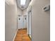 Hallway featuring hardwood floors, open doorways, and a ceiling light at 1573 Avleigh Cir, Orlando, FL 32824