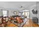 Large living room with hardwood floors, comfortable seating, and multiple access points to other rooms at 1573 Avleigh Cir, Orlando, FL 32824