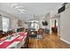 Open-concept living room boasts hardwood floors, modern lighting, neutral walls, and access to other living spaces at 1573 Avleigh Cir, Orlando, FL 32824