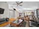 Spacious living room with hardwood floors, a ceiling fan, and views of dining and kitchen at 1573 Avleigh Cir, Orlando, FL 32824