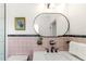 Bathroom featuring pink tiles, an oval mirror, and black hardware and stylish fixtures at 1604 Sylvester Rd, Lakeland, FL 33803
