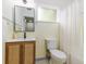 The bathroom has cream-colored tiled walls and a stylish vanity with a black faucet at 1604 Sylvester Rd, Lakeland, FL 33803