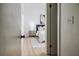 Hallway view to a modern bedroom with a luxurious bed and calming decor at 1604 Sylvester Rd, Lakeland, FL 33803