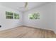 A bright bedroom with neutral walls, wood-look floors, and windows to the outside at 1604 Sylvester Rd, Lakeland, FL 33803