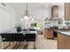 Bright dining room open to the kitchen features a modern chandelier and seating for six at 1604 Sylvester Rd, Lakeland, FL 33803