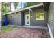 Home exterior featuring a brick patio, back door, and tidy yard space at 1604 Sylvester Rd, Lakeland, FL 33803
