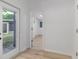 Bright hallway featuring neutral walls and wood-look floors at 1604 Sylvester Rd, Lakeland, FL 33803