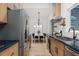 Modern kitchen featuring stainless steel appliances, dark countertops, and a view to the dining area at 1604 Sylvester Rd, Lakeland, FL 33803