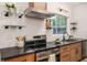 Updated kitchen featuring stainless steel appliances, sleek countertops, and open shelving at 1604 Sylvester Rd, Lakeland, FL 33803