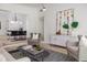 Bright living room with modern furniture, stylish decor, and hardwood floors at 1604 Sylvester Rd, Lakeland, FL 33803