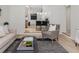Open-concept living room with a view into the dining room and stylish, modern furniture at 1604 Sylvester Rd, Lakeland, FL 33803