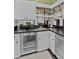 Compact bar area with a stainless steel beverage cooler and open shelving for glasses and liquor at 1760 Old Bartow Eagle Lake Rd, Bartow, FL 33830