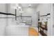 White tiled bathroom with black trim, double sinks, and modern fixtures at 1760 Old Bartow Eagle Lake Rd, Bartow, FL 33830