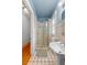 Bathroom featuring tiled walls, stall shower, and hardwood floors in hallway at 1760 Old Bartow Eagle Lake Rd, Bartow, FL 33830