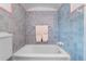 Traditional bathroom with blue tiled walls, a white porcelain tub, and vintage fixtures at 1760 Old Bartow Eagle Lake Rd, Bartow, FL 33830