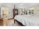 Bedroom with a four-poster bed, wood floors, and access to a walk-in closet at 1760 Old Bartow Eagle Lake Rd, Bartow, FL 33830