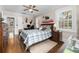 Bedroom with wooden bed frame, ceiling fan and natural light from the windows at 1760 Old Bartow Eagle Lake Rd, Bartow, FL 33830
