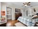 Bedroom featuring a wooden dresser and framed art, illuminated by natural light from the window at 1760 Old Bartow Eagle Lake Rd, Bartow, FL 33830