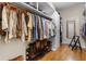Walk-in closet with organized clothing and shoe storage, and wooden floors at 1760 Old Bartow Eagle Lake Rd, Bartow, FL 33830