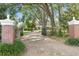 Estate home behind gated entry and mature trees and lush landscaping at 1760 Old Bartow Eagle Lake Rd, Bartow, FL 33830