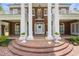 Brick steps lead up to the grand entrance with large white columns and a welcoming front door at 1760 Old Bartow Eagle Lake Rd, Bartow, FL 33830