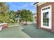 A brick home with a white-trimmed door leading to a large outdoor terrace at 1760 Old Bartow Eagle Lake Rd, Bartow, FL 33830