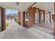 Covered porch with brick columns and tiled floor with arched windows at 1760 Old Bartow Eagle Lake Rd, Bartow, FL 33830