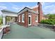 A brick home with a white trimmed door surrounded by white-trimmed windows and a matching brick chimney at 1760 Old Bartow Eagle Lake Rd, Bartow, FL 33830