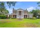 Stately brick home featuring a grand facade, white columns, balcony and a lush green lawn at 1760 Old Bartow Eagle Lake Rd, Bartow, FL 33830