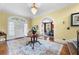 Elegant foyer with hardwood floors, a round table with flowers, and a view into the dining room at 1760 Old Bartow Eagle Lake Rd, Bartow, FL 33830