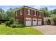 A three car garage with white doors is connected to the main house at 1760 Old Bartow Eagle Lake Rd, Bartow, FL 33830