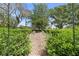 Lush garden with neatly trimmed hedges and gravel pathway at 1760 Old Bartow Eagle Lake Rd, Bartow, FL 33830