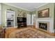 Open living room with fireplace, hardwood floors, and natural light at 1760 Old Bartow Eagle Lake Rd, Bartow, FL 33830