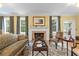 Cozy living room featuring a fireplace, traditional furniture, and natural light from the windows at 1760 Old Bartow Eagle Lake Rd, Bartow, FL 33830