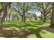 Lush property with mature trees and estate home in the distance at 1760 Old Bartow Eagle Lake Rd, Bartow, FL 33830