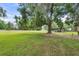 Expansive manicured green lawn with a large shady tree and covered pavilion at 1760 Old Bartow Eagle Lake Rd, Bartow, FL 33830
