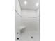 Tiled shower with built-in seating, and white tiled walls and black and white tiled floor at 1760 Old Bartow Eagle Lake Rd, Bartow, FL 33830