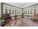 Bright sunroom featuring unique tile flooring, comfortable chairs, and abundant natural light through large windows at 1760 Old Bartow Eagle Lake Rd, Bartow, FL 33830