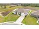 Aerial view of a modern home showcasing its manicured front yard at 185 Heritage Park Ln, Mulberry, FL 33860