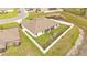 Aerial view of home featuring a large backyard, playground, and perimeter fencing at 185 Heritage Park Ln, Mulberry, FL 33860