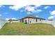 Spacious backyard with green grass, a white fence, a playground and covered patio at 185 Heritage Park Ln, Mulberry, FL 33860