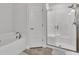 Clean and bright bathroom with soaking tub and frameless glass shower enclosure at 185 Heritage Park Ln, Mulberry, FL 33860