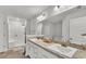 Bright bathroom with double vanity, quartz countertops, soaking tub, and separate shower at 185 Heritage Park Ln, Mulberry, FL 33860