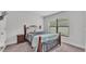 Comfortable bedroom featuring a decorative bed frame and a neutral carpet at 185 Heritage Park Ln, Mulberry, FL 33860