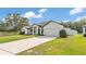 Charming single-story home featuring a long driveway and attached two-car garage at 185 Heritage Park Ln, Mulberry, FL 33860